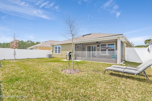 53 Dovetail Cir, Saint Augustine, FL 32095 - rear view of property with a sunroom, a fenced backyard, central air condition unit, and a yard