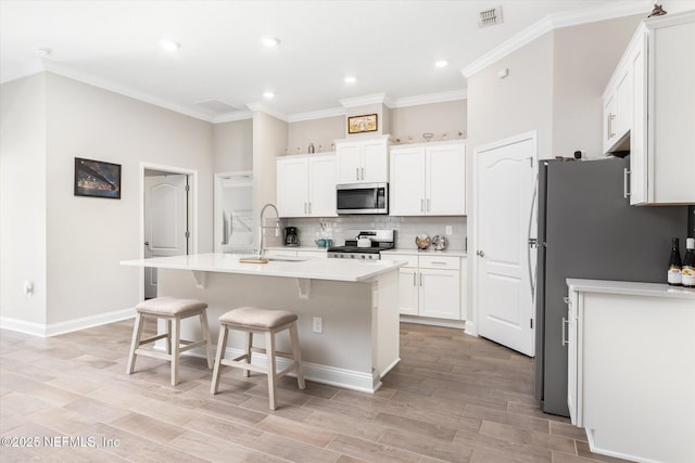 53 Dovetail Cir, Saint Augustine, FL 32095 - kitchen featuring decorative backsplash, visible vents, appliances with stainless steel finishes, a sink, and white cabinetry