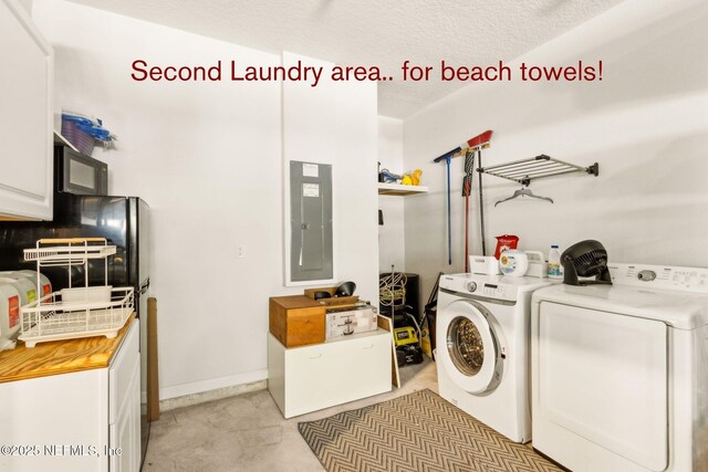 laundry room with electric panel, a textured ceiling, washing machine and clothes dryer, cabinet space, and baseboards