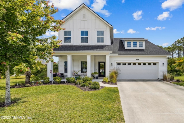 view of front of property featuring a front lawn, a garage, board and batten siding, concrete driveway, and covered porch
