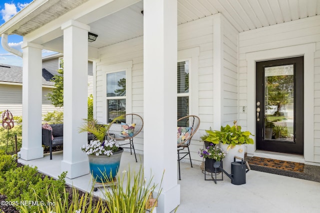 view of exterior entry featuring a porch