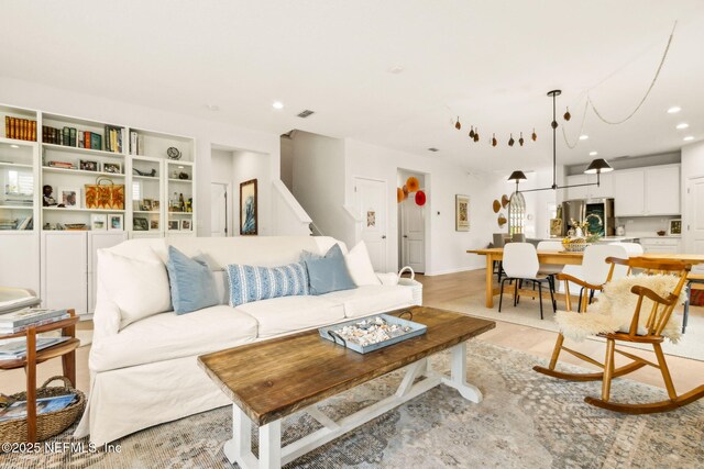 living area featuring recessed lighting and visible vents