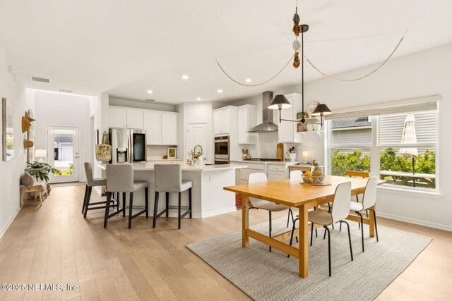 dining space with recessed lighting, baseboards, a wealth of natural light, and light wood-style flooring