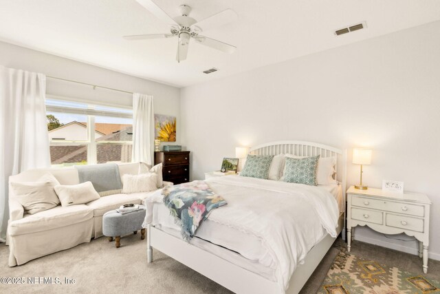 carpeted bedroom with visible vents and ceiling fan