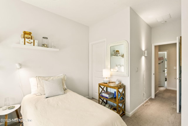 carpeted bedroom featuring baseboards