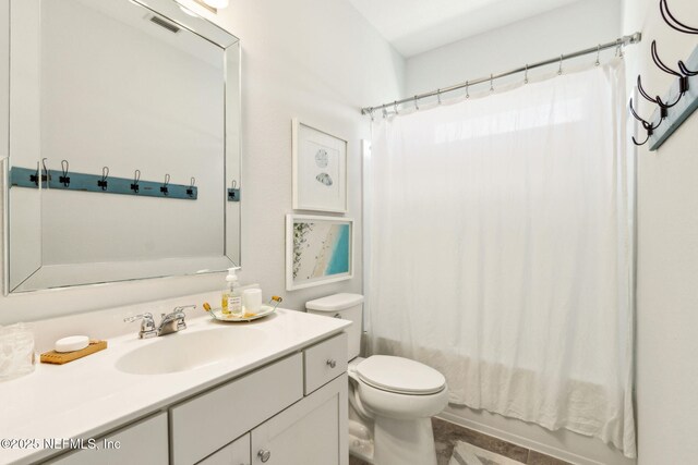 full bath with vanity, shower / bath combo with shower curtain, and toilet