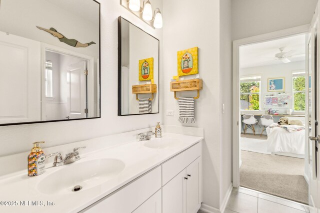 bathroom with ensuite bathroom, a sink, a ceiling fan, and double vanity