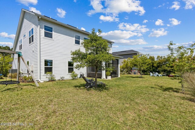 rear view of property with a lawn