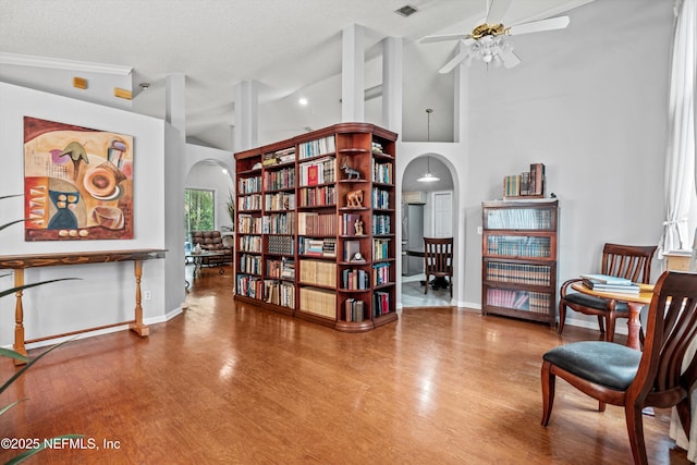 1105 Pine Mill Ln, Ponte Vedra Beach, FL 32082 - sitting room with arched walkways, ceiling fan, wood finished floors, a high ceiling, and baseboards