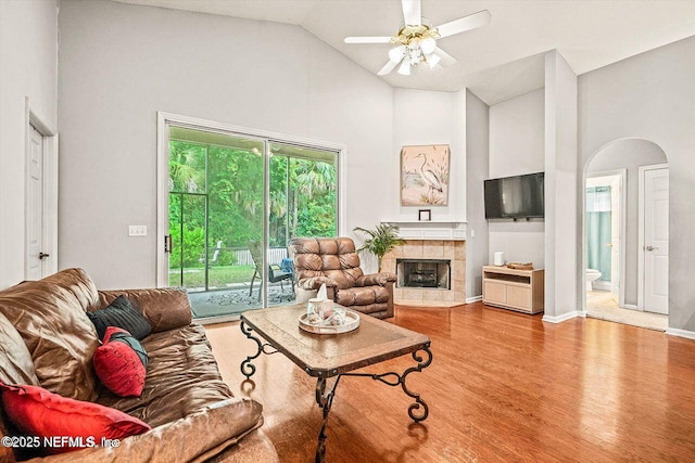 1105 Pine Mill Ln, Ponte Vedra Beach, FL 32082 - living area featuring a fireplace, high vaulted ceiling, a ceiling fan, wood finished floors, and arched walkways