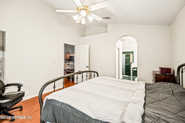 1105 Pine Mill Ln, Ponte Vedra Beach, FL 32082 - bedroom featuring vaulted ceiling, wood finished floors, arched walkways, baseboards, and a ceiling fan