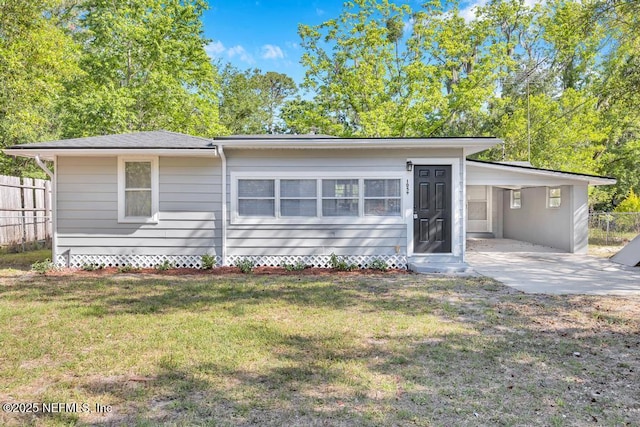 1059 Little Ruth Rd, Green Cove Springs, FL 32043 - view of front of house featuring fence, concrete driveway, an attached carport, and a front lawn
