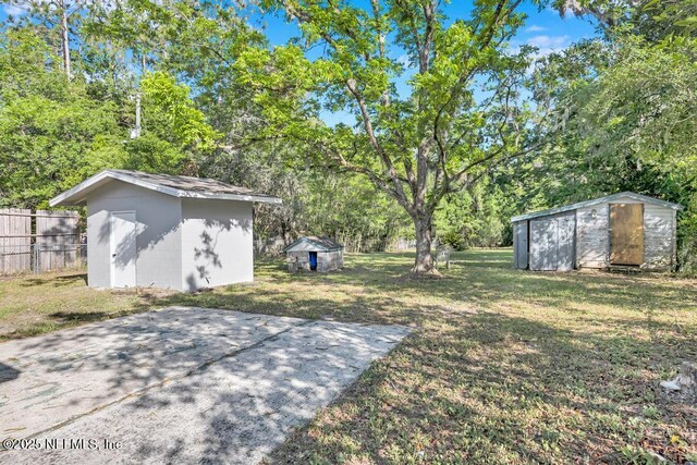 1059 Little Ruth Rd, Green Cove Springs, FL 32043 - view of yard featuring an outbuilding, fence, and a storage shed