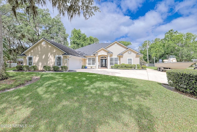 single story home with a garage, stucco siding, driveway, and a front lawn