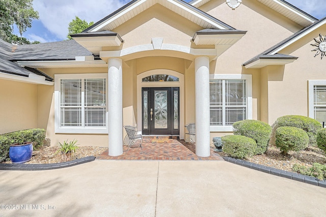 property entrance featuring stucco siding