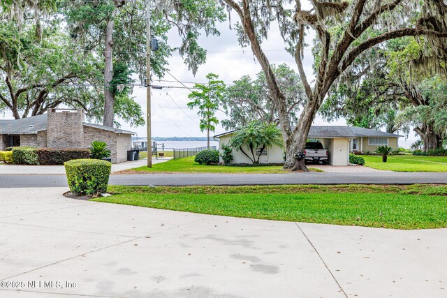 7685 River Ave, Fleming Island, FL 32003 - exterior space featuring fence, a front yard, and aphalt driveway