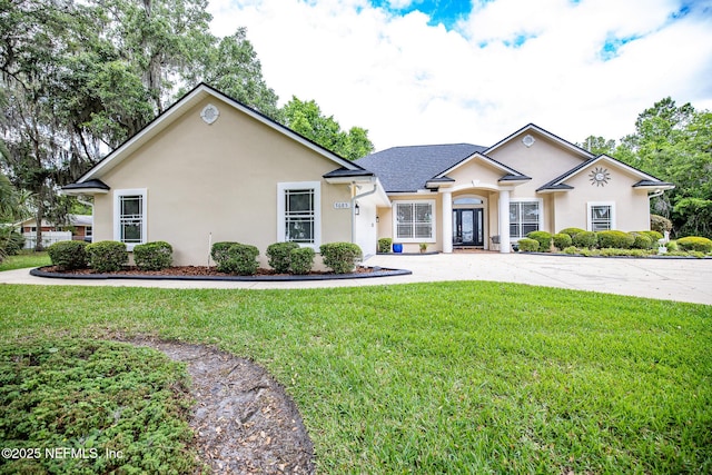 ranch-style house with a front lawn and stucco siding