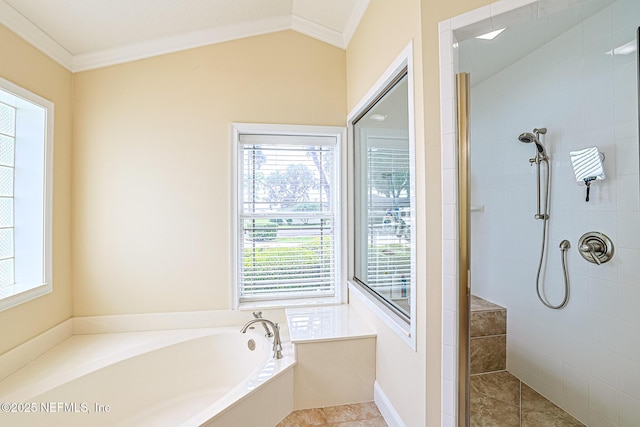 bathroom featuring a garden tub, ornamental molding, a tile shower, and a wealth of natural light