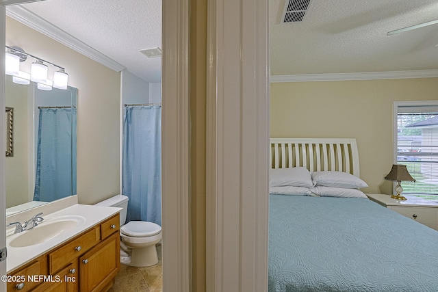 full bathroom featuring crown molding, toilet, a textured ceiling, and vanity