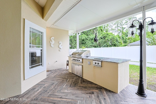 view of patio featuring fence, a wooden deck, grilling area, and area for grilling