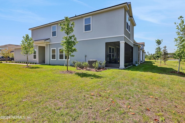 497 Coastline Way, Saint Augustine, FL 32092 - back of property with a yard, cooling unit, stucco siding, and a sunroom