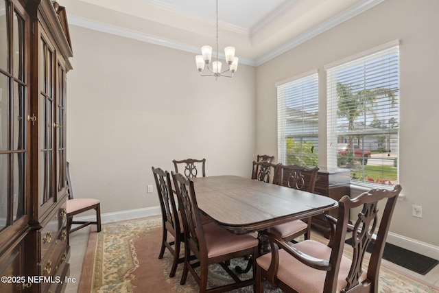 149 San Telmo Ct, Saint Augustine, FL 32095 - dining space with ornamental molding, a notable chandelier, a tray ceiling, and baseboards