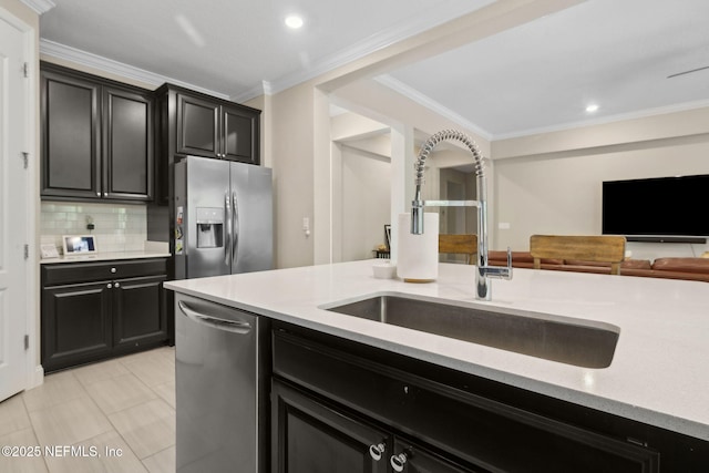 149 San Telmo Ct, Saint Augustine, FL 32095 - kitchen featuring a sink, stainless steel appliances, crown molding, tasteful backsplash, and dark cabinetry