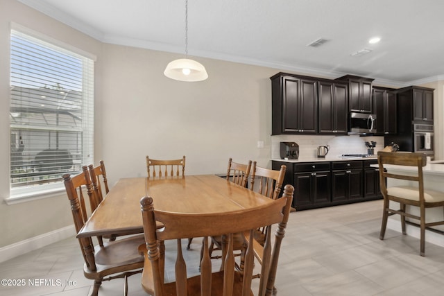 149 San Telmo Ct, Saint Augustine, FL 32095 - dining space with crown molding, plenty of natural light, visible vents, and baseboards