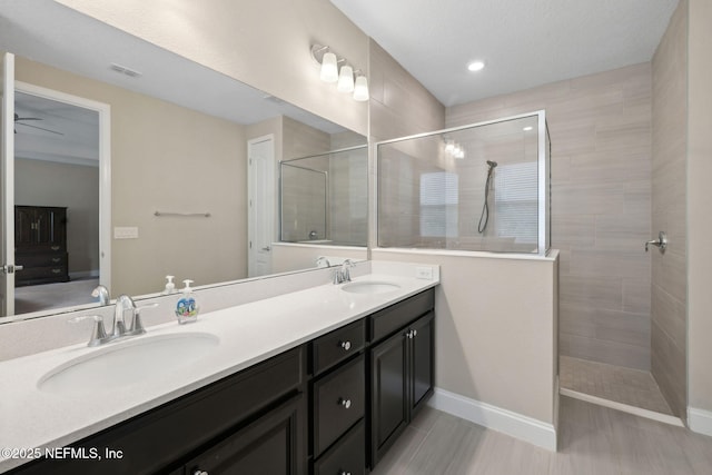 149 San Telmo Ct, Saint Augustine, FL 32095 - bathroom with ceiling fan, walk in shower, visible vents, and a sink