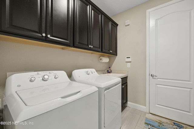 149 San Telmo Ct, Saint Augustine, FL 32095 - laundry area with a sink, cabinet space, baseboards, and washer and dryer