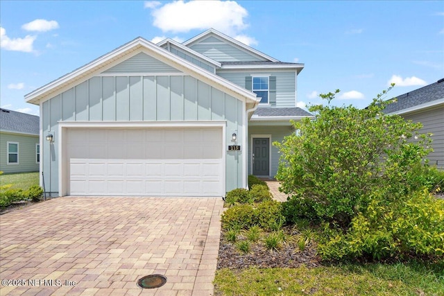 115 Beauclair Blvd, Saint Augustine, FL 32084 - view of front of home featuring an attached garage, decorative driveway, and board and batten siding
