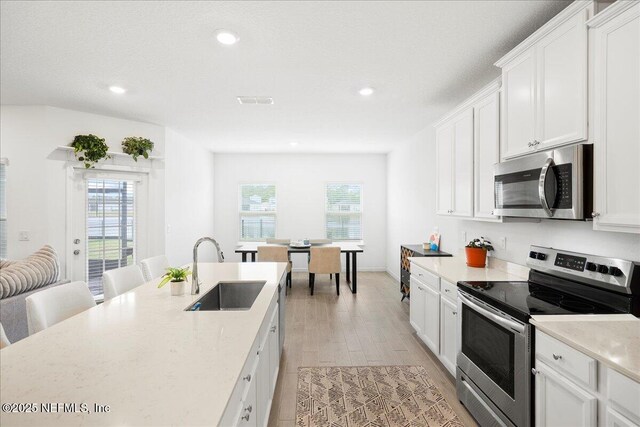 115 Beauclair Blvd, Saint Augustine, FL 32084 - kitchen featuring recessed lighting, a sink, white cabinets, and stainless steel appliances