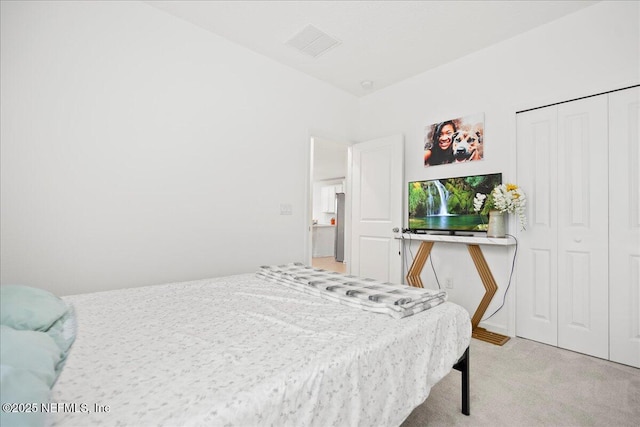 115 Beauclair Blvd, Saint Augustine, FL 32084 - bedroom with a closet, freestanding refrigerator, light colored carpet, and visible vents