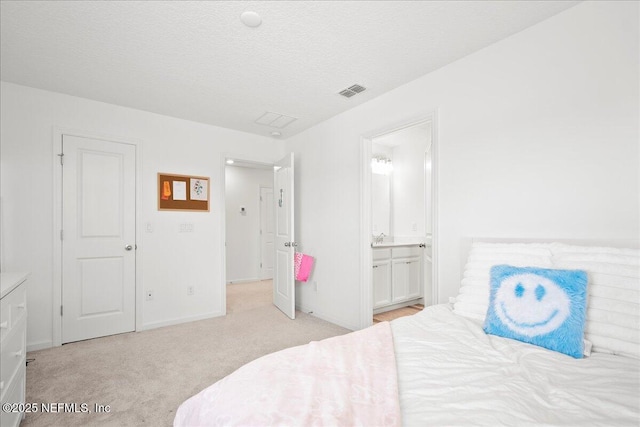 115 Beauclair Blvd, Saint Augustine, FL 32084 - bedroom with light colored carpet, a textured ceiling, baseboards, ensuite bathroom, and visible vents