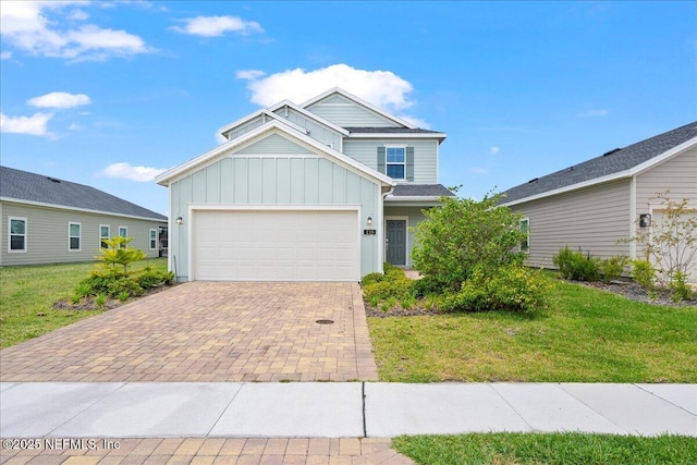 115 Beauclair Blvd, Saint Augustine, FL 32084 - traditional home featuring a garage, decorative driveway, a front lawn, and board and batten siding