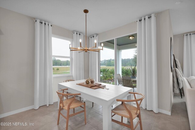 950 Rooster Hallow Way, Middleburg, FL 32068 - dining room featuring light tile patterned floors, baseboards, and a notable chandelier