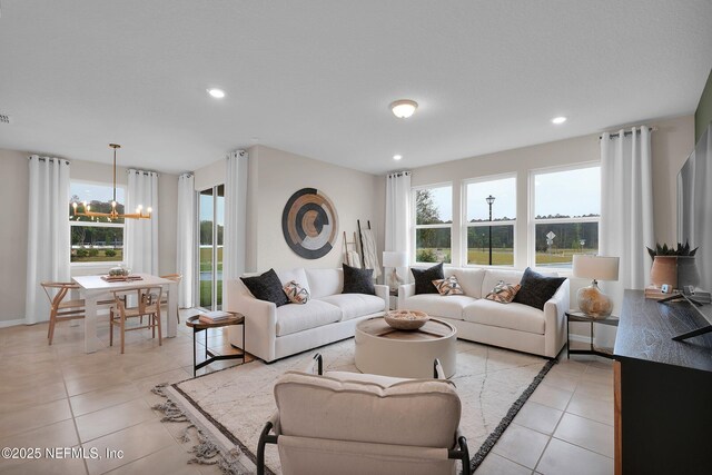 950 Rooster Hallow Way, Middleburg, FL 32068 - living area featuring a healthy amount of sunlight, recessed lighting, light tile patterned flooring, and a notable chandelier