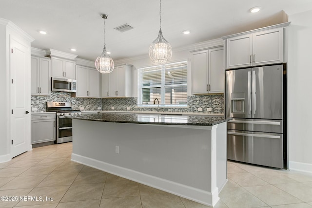 kitchen with visible vents, tasteful backsplash, light tile patterned floors, dark stone counters, and stainless steel appliances