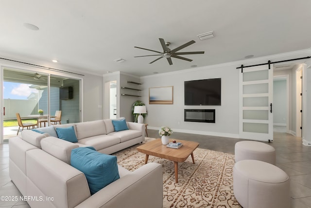 tiled living area with a ceiling fan, visible vents, crown molding, a barn door, and baseboards
