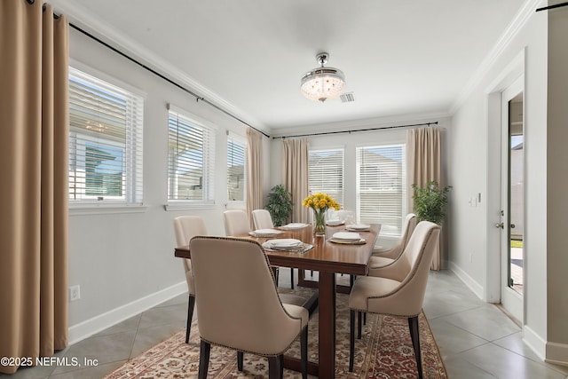 dining room featuring baseboards, visible vents, ornamental molding, and light tile patterned floors