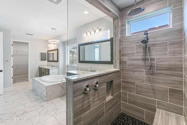 full bath with vanity, walk in shower, a bath, and marble finish floor