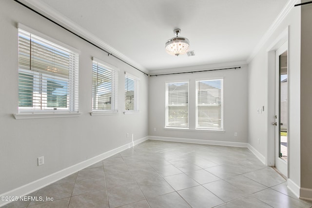 spare room with crown molding, light tile patterned floors, baseboards, and visible vents