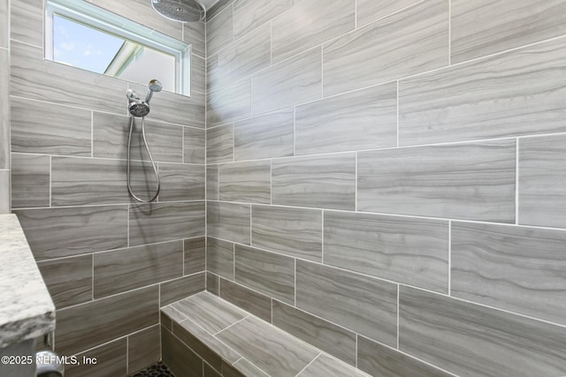 full bath with a tile shower