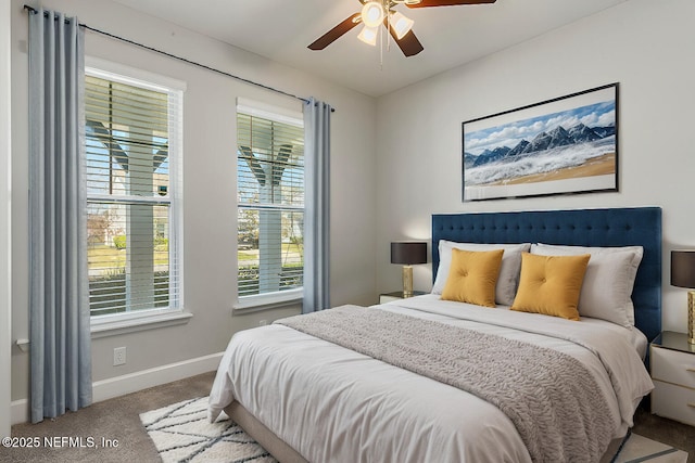 carpeted bedroom with baseboards and a ceiling fan