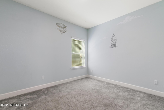 empty room with baseboards and carpet floors
