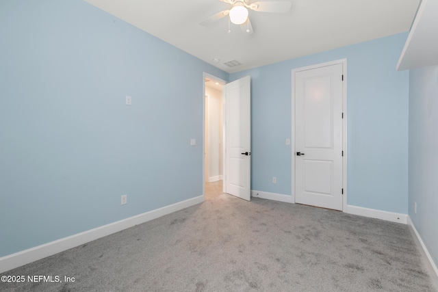unfurnished bedroom featuring baseboards, carpet flooring, and visible vents