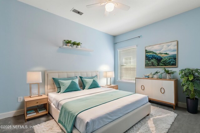 carpeted bedroom featuring baseboards, visible vents, and ceiling fan