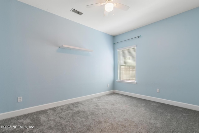empty room featuring visible vents, a ceiling fan, baseboards, and carpet flooring