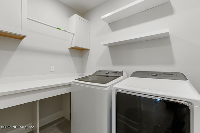 clothes washing area with tile patterned floors, cabinet space, and washing machine and dryer