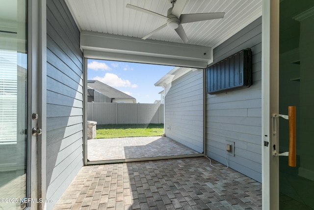 exterior space with ceiling fan and fence